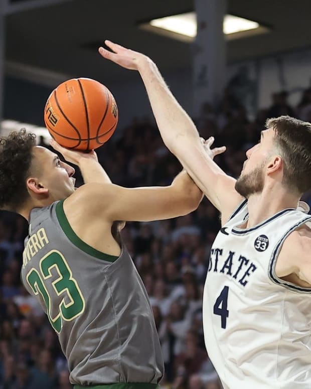 Feb 26, 2022; Logan, Utah, USA; Colorado State Rams guard Isaiah Rivera (23) shoots around Utah State Aggies forward Brandon Horvath (4) in the first half at Dee Glen Smith Spectrum. Mandatory Credit: Rob Gray-USA TODAY Sports